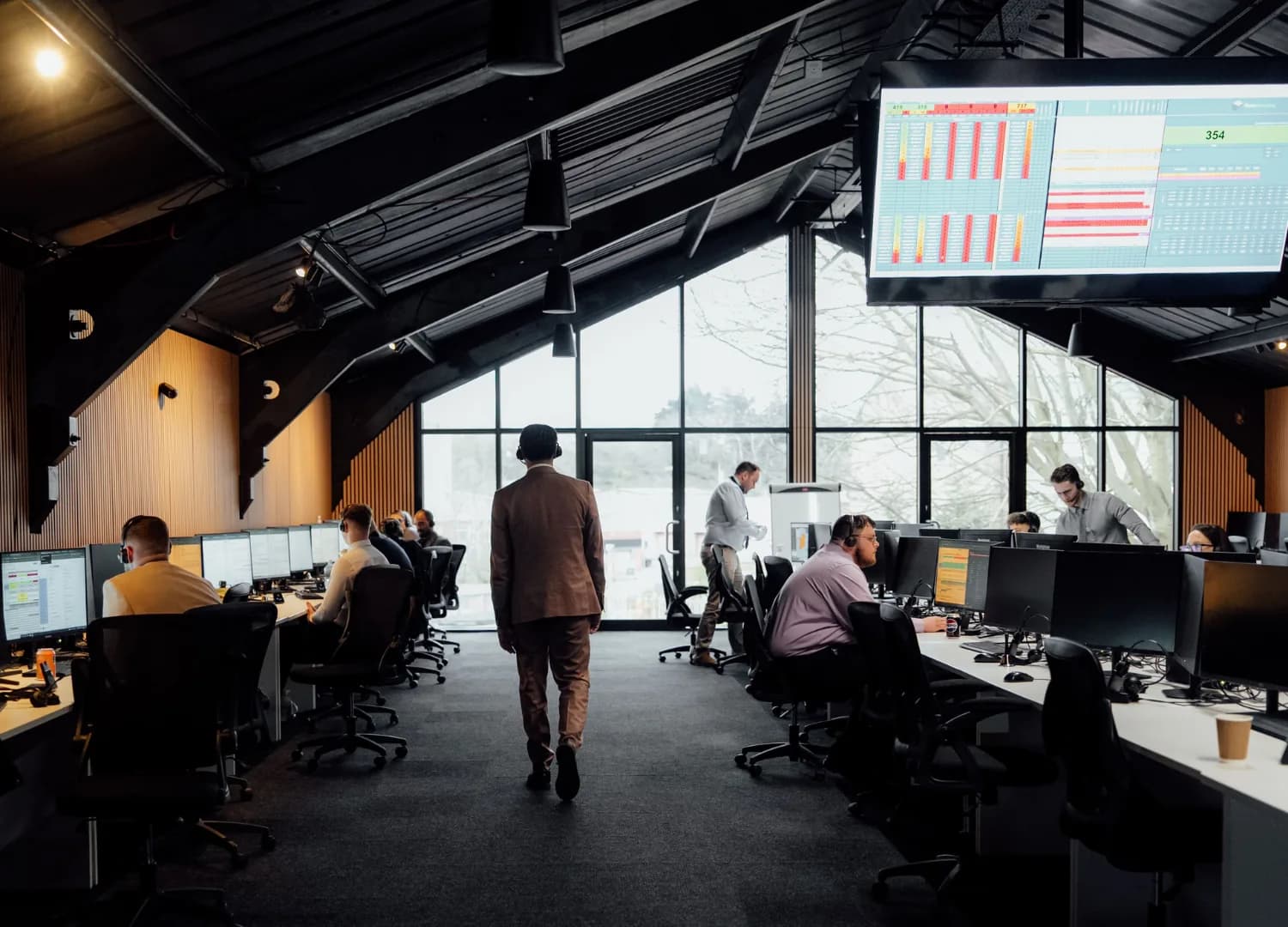 The Watts Marketing call centre floor in Norwich, with agents at desks under a live appointment board.